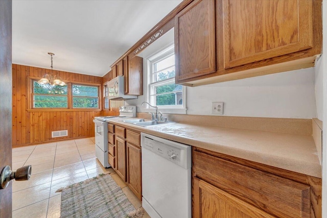 1113 Brandon Ave SW, Roanoke, VA 24015 - kitchen featuring white appliances, a chandelier, brown cabinetry, light countertops, and a sink