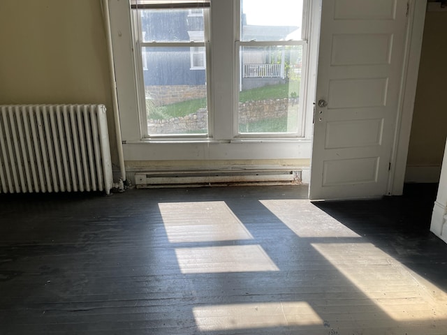 832 Patterson Ave SW, Roanoke, VA 24016 - unfurnished room with radiator, a baseboard radiator, and hardwood / wood-style floors