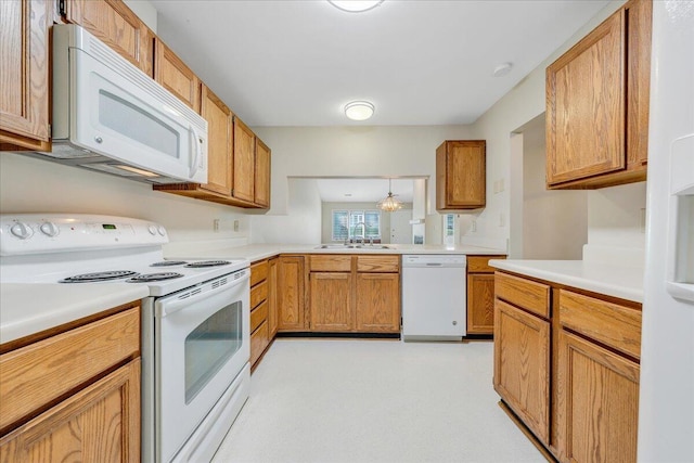 8506 Pine Hurst Cir, Roanoke, VA 24019 - kitchen featuring white appliances, a sink, light countertops, and brown cabinets