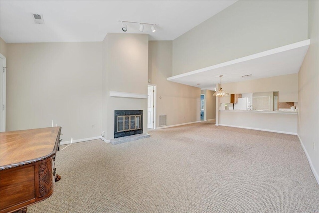 8506 Pine Hurst Cir, Roanoke, VA 24019 - unfurnished living room featuring high vaulted ceiling, track lighting, a chandelier, carpet floors, and a fireplace