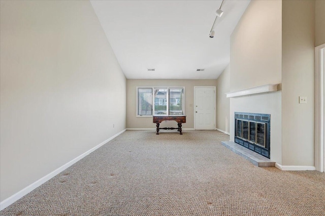 8506 Pine Hurst Cir, Roanoke, VA 24019 - unfurnished living room featuring carpet floors, baseboards, a glass covered fireplace, track lighting, and vaulted ceiling