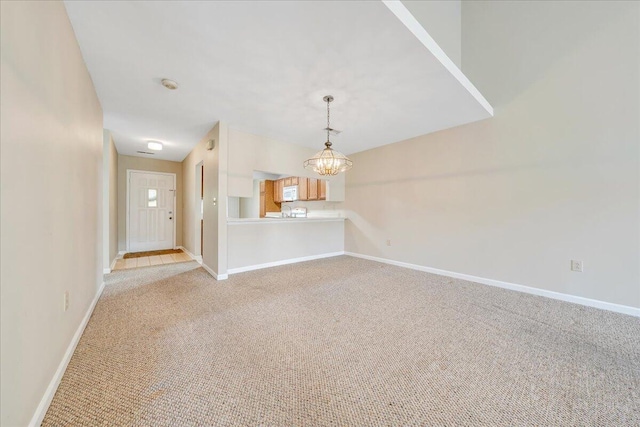 8506 Pine Hurst Cir, Roanoke, VA 24019 - unfurnished living room featuring a chandelier, light colored carpet, and baseboards