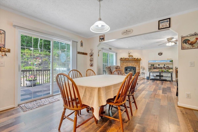 384 White Oak Ln, New Castle, VA 24127 - dining room featuring a textured ceiling, hardwood / wood-style floors, ceiling fan, ornamental molding, and a fireplace