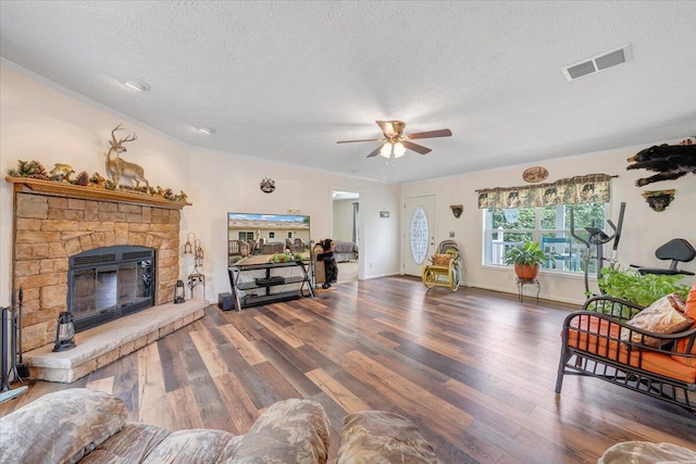 384 White Oak Ln, New Castle, VA 24127 - living room featuring a textured ceiling, wood finished floors, ceiling fan, and a stone fireplace