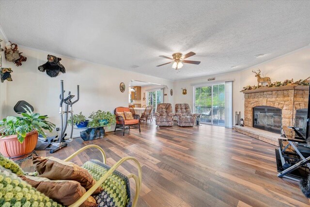 384 White Oak Ln, New Castle, VA 24127 - living room featuring a ceiling fan, wood finished floors, a textured ceiling, and a fireplace