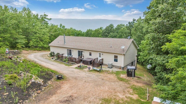 384 White Oak Ln, New Castle, VA 24127 - view of front facade with a wooden deck, a view of trees, central air condition unit, and driveway