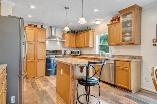 384 White Oak Ln, New Castle, VA 24127 - kitchen featuring wall chimney range hood, appliances with stainless steel finishes, light wood-type flooring, a center island, and a textured ceiling