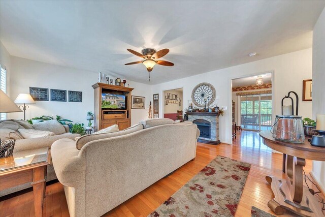 6119 Carolina Trl, Roanoke, VA 24019 - living area featuring healthy amount of natural light, a ceiling fan, light wood-type flooring, and a fireplace