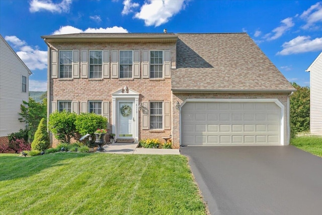 6119 Carolina Trl, Roanoke, VA 24019 - colonial home with asphalt driveway, a garage, a front lawn, and a shingled roof