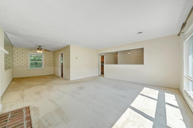 1207 Laymantown Rd, Troutville, VA 24175 - unfurnished living room with carpet floors, a ceiling fan, wallpapered walls, and baseboards