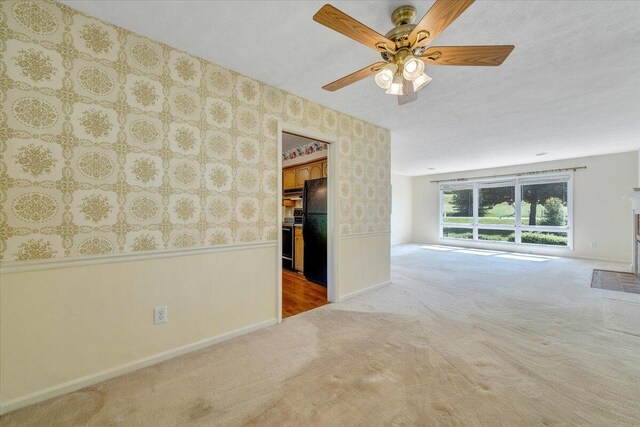 1207 Laymantown Rd, Troutville, VA 24175 - unfurnished room featuring wallpapered walls, carpet floors, baseboards, ceiling fan, and a wainscoted wall