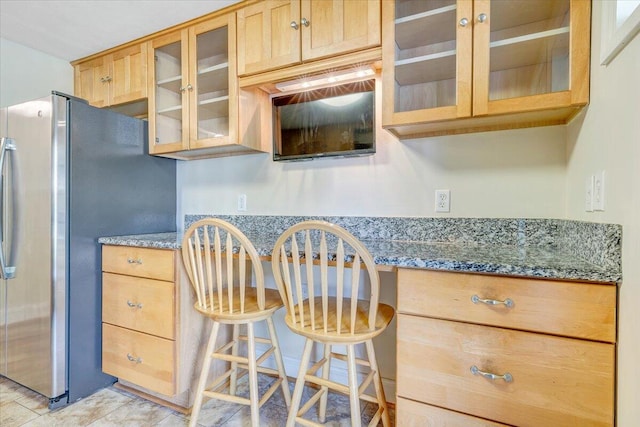 1207 Laymantown Rd, Troutville, VA 24175 - kitchen featuring freestanding refrigerator, glass insert cabinets, stone counters, a kitchen bar, and built in desk