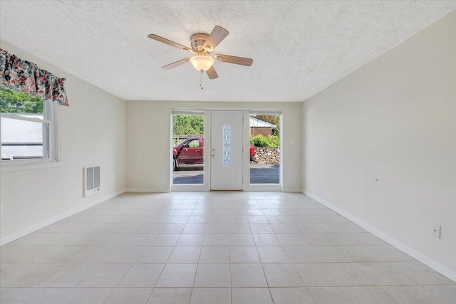 1207 Laymantown Rd, Troutville, VA 24175 - empty room featuring a textured ceiling, a ceiling fan, light tile patterned floors, and baseboards