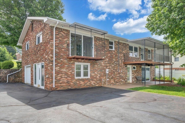 1207 Laymantown Rd, Troutville, VA 24175 - rear view of property with brick siding, a garage, and a balcony
