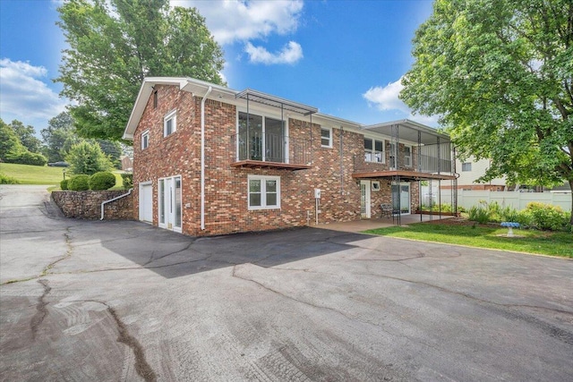 1207 Laymantown Rd, Troutville, VA 24175 - view of front of property featuring brick siding, a garage, asphalt driveway, and a balcony