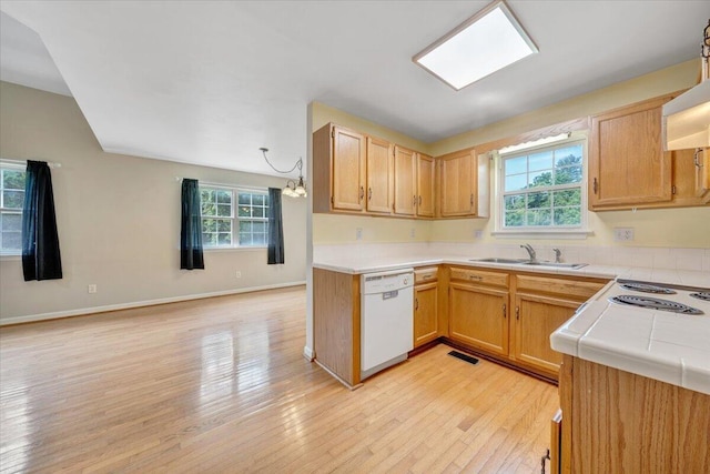 715 N Stonewall St, Salem, VA 24153 - kitchen featuring white dishwasher, tile counters, light wood finished floors, a chandelier, and ventilation hood