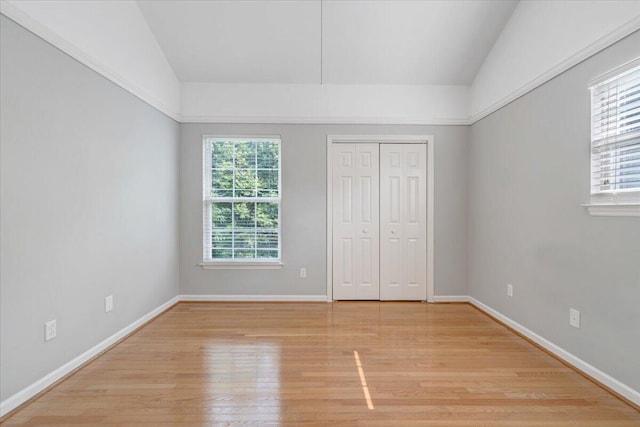 715 N Stonewall St, Salem, VA 24153 - unfurnished bedroom featuring light wood finished floors, lofted ceiling, and a closet