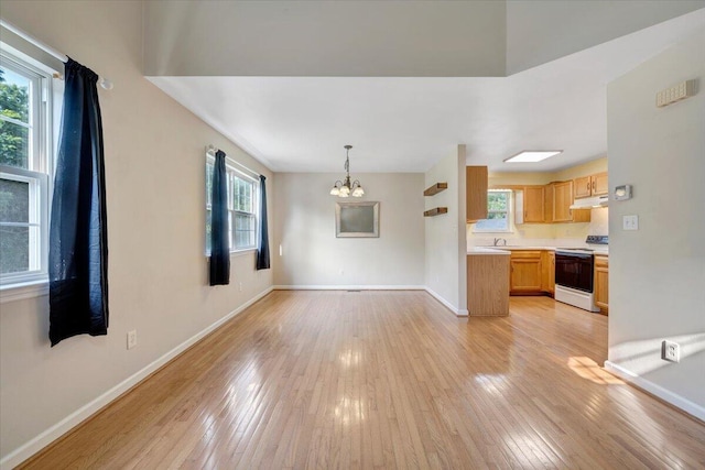 715 N Stonewall St, Salem, VA 24153 - unfurnished living room featuring a chandelier and light wood finished floors