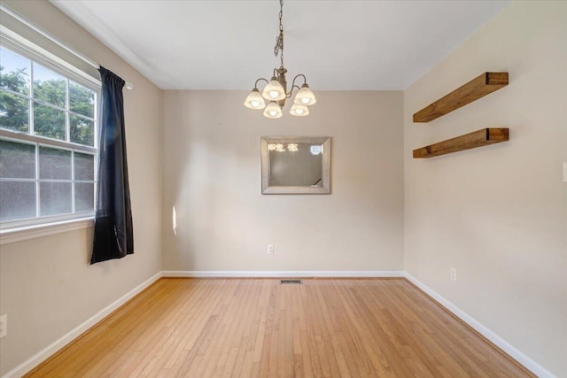 715 N Stonewall St, Salem, VA 24153 - spare room featuring light wood-style floors and a chandelier
