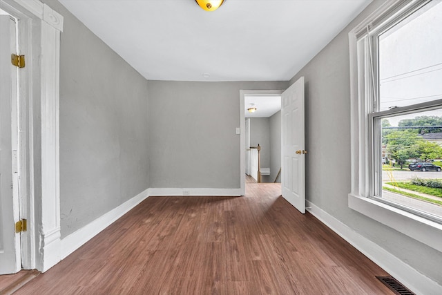 1002 Stewart Ave SE, Roanoke, VA 24013 - spare room featuring dark wood-type flooring and baseboards