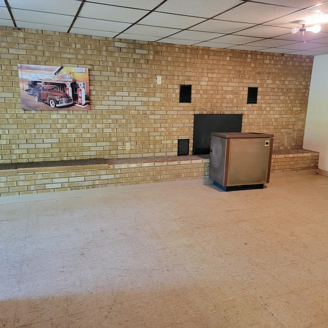 1160 Moorman Rd, Hardy, VA 24101 - basement featuring a paneled ceiling, tile patterned floors, and brick wall