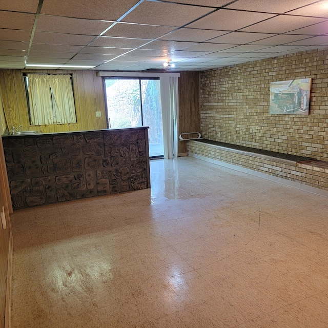 1160 Moorman Rd, Hardy, VA 24101 - basement featuring tile patterned floors, a paneled ceiling, brick wall, and wooden walls