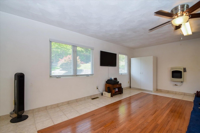 285 Dixon Dr, Hardy, VA 24101 - unfurnished living room with heating unit, wood finished floors, a ceiling fan, and baseboards