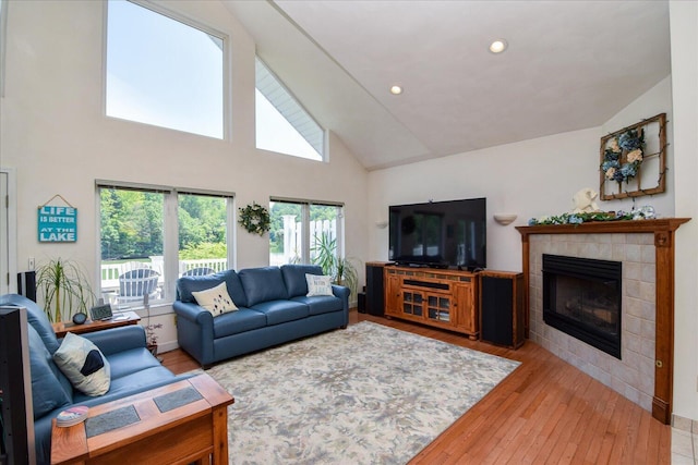 285 Dixon Dr, Hardy, VA 24101 - living area with a tile fireplace, high vaulted ceiling, light wood finished floors, and recessed lighting