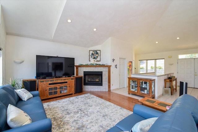 285 Dixon Dr, Hardy, VA 24101 - living room featuring vaulted ceiling, a tile fireplace, recessed lighting, and light wood-type flooring