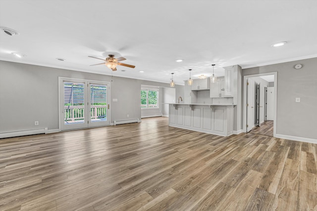 395 Middle Valley Rd, Hardy, VA 24101 - unfurnished living room with a ceiling fan, ornamental molding, baseboard heating, light wood-type flooring, and a baseboard radiator