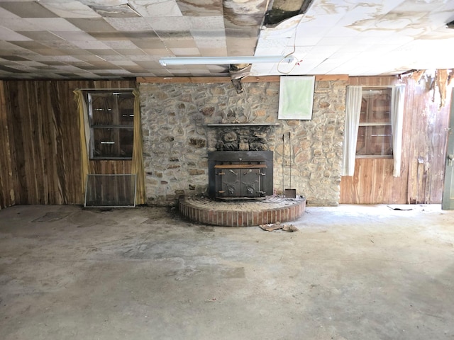 115 Wrights Branch Rd, New Castle, VA 24127 - basement with wood walls, a wood stove, and a paneled ceiling