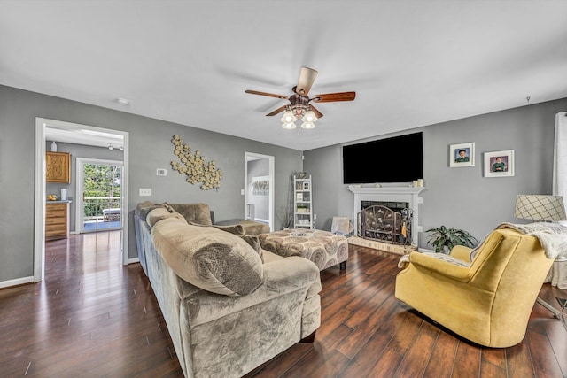 6131 Carolina Trl, Roanoke, VA 24019 - living room with ceiling fan, dark wood-style flooring, a fireplace with raised hearth, and baseboards