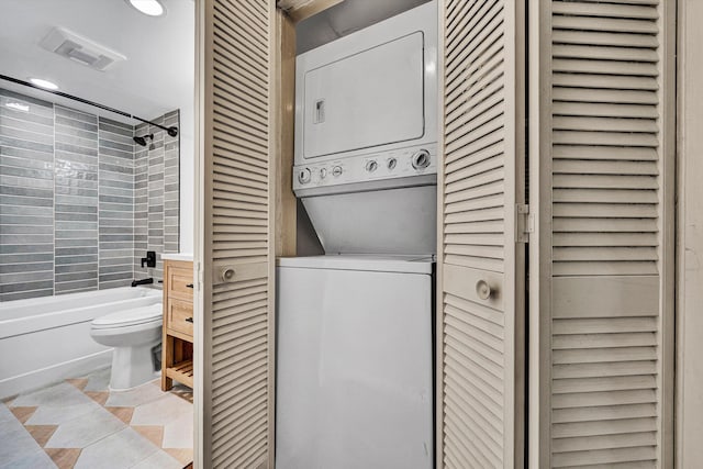 5260 Crossbow Cir Unit 9E, Roanoke, VA 24018 - bathroom featuring a closet, stacked washer / drying machine, toilet, washtub / shower combination, and recessed lighting