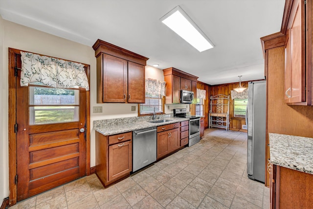 2527 Northminster Rd NW, Roanoke, VA 24012 - kitchen with appliances with stainless steel finishes, a sink, brown cabinets, light stone counters, and wooden walls