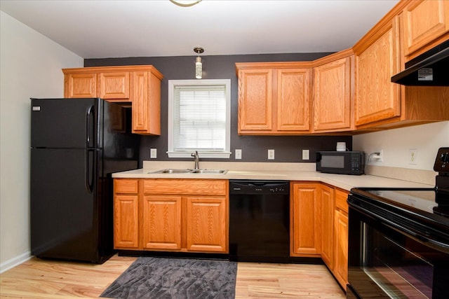 1903 Archbold Ave NE, Roanoke, VA 24012 - kitchen with black appliances, a sink, custom range hood, light countertops, and light wood-style flooring