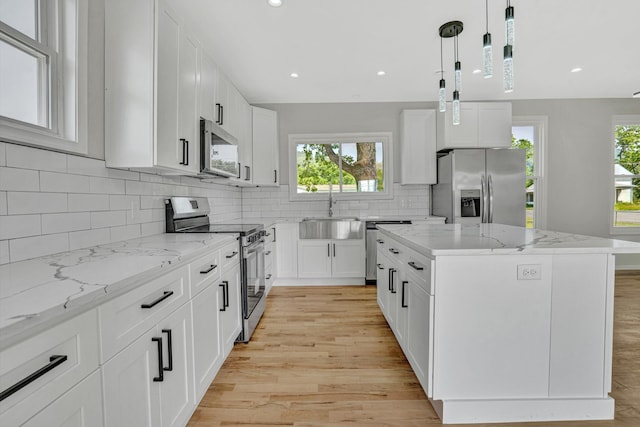 702 Commerce Ave, Iron Gate, VA 24448 - kitchen featuring stainless steel appliances, a sink, light wood finished floors, a kitchen island, and recessed lighting