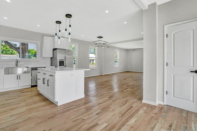 702 Commerce Ave, Iron Gate, VA 24448 - kitchen with a sink, appliances with stainless steel finishes, white cabinets, healthy amount of natural light, and recessed lighting