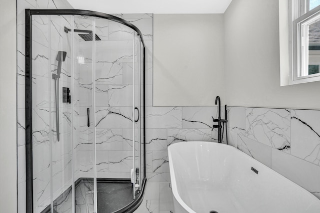702 Commerce Ave, Iron Gate, VA 24448 - bathroom featuring a soaking tub, healthy amount of natural light, a marble finish shower, and tile walls