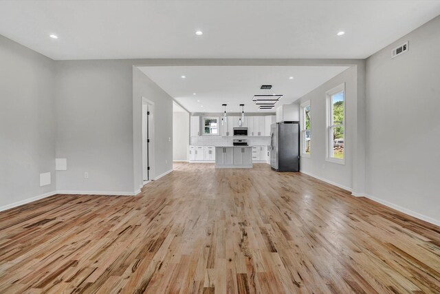 702 Commerce Ave, Iron Gate, VA 24448 - unfurnished living room featuring light wood-style floors, baseboards, and recessed lighting