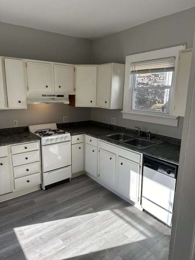 605 6th St SE, Roanoke, VA 24013 - kitchen featuring white gas range oven, dishwashing machine, under cabinet range hood, a sink, and dark countertops
