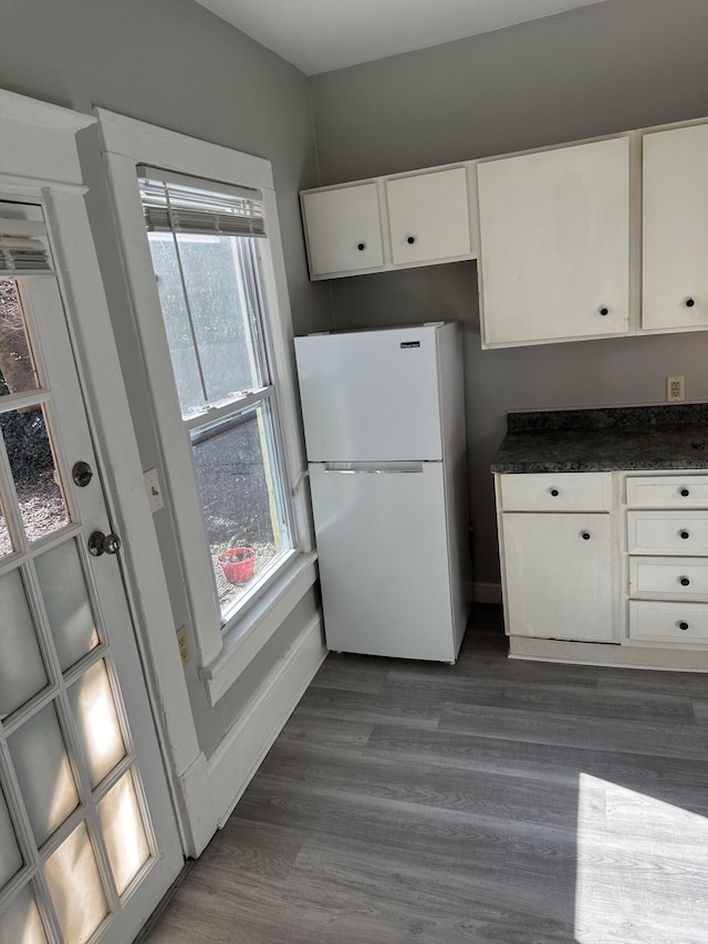605 6th St SE, Roanoke, VA 24013 - kitchen featuring freestanding refrigerator, white cabinets, dark countertops, baseboards, and dark wood-style flooring