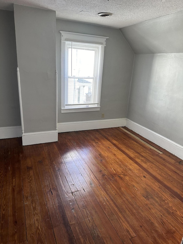 605 6th St SE, Roanoke, VA 24013 - bonus room featuring wood-type flooring, vaulted ceiling, a textured ceiling, and baseboards