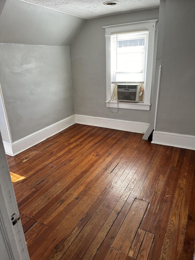 605 6th St SE, Roanoke, VA 24013 - additional living space featuring cooling unit, hardwood / wood-style flooring, baseboards, vaulted ceiling, and a textured ceiling