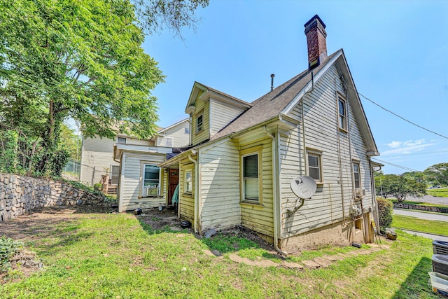 605 6th St SE, Roanoke, VA 24013 - rear view of house featuring a lawn, a chimney, and a shingled roof
