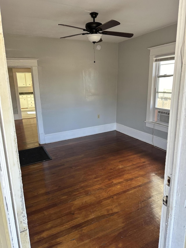 605 6th St SE, Roanoke, VA 24013 - empty room with baseboards, dark wood-type flooring, ceiling fan, and cooling unit