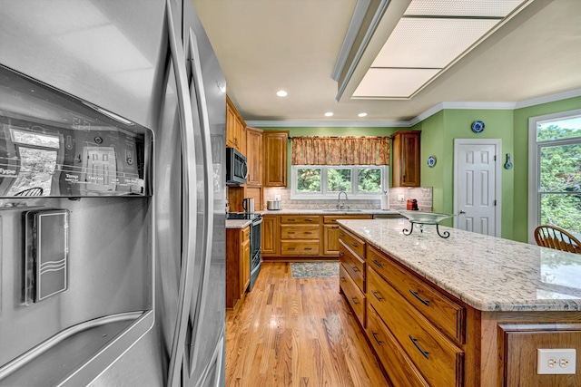 6355 Juliet Ct, Roanoke, VA 24018 - kitchen with stainless steel appliances, a sink, brown cabinetry, light wood-style floors, and ornamental molding