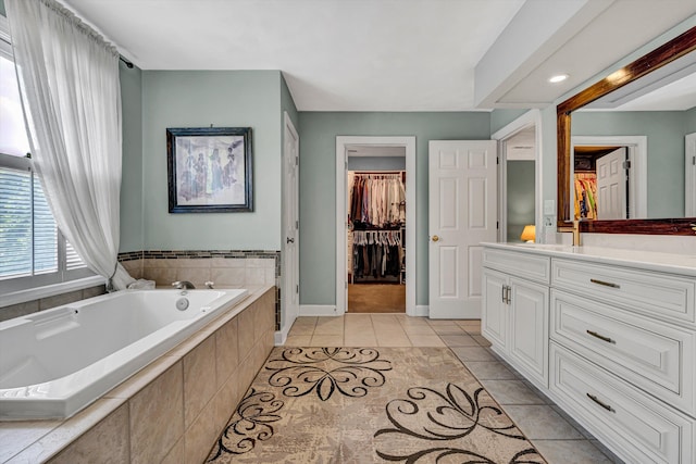 6355 Juliet Ct, Roanoke, VA 24018 - bathroom featuring vanity, a garden tub, tile patterned flooring, a walk in closet, and baseboards
