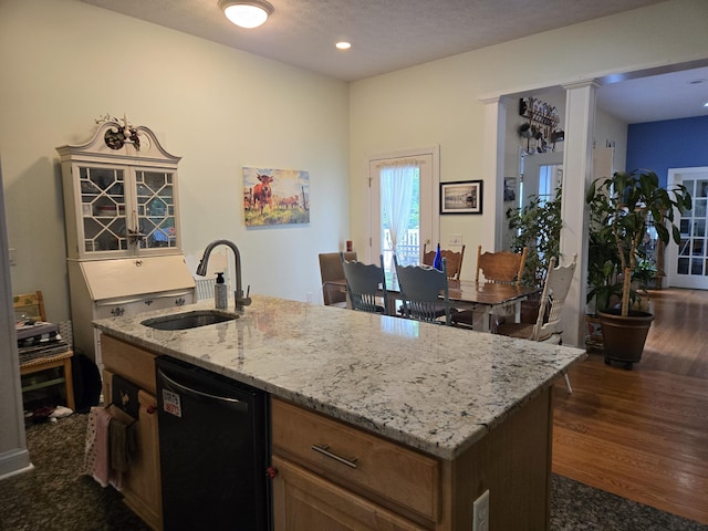 6733 Floyd Hwy S, Willis, VA 24380 - kitchen featuring a sink, black dishwasher, light stone countertops, an island with sink, and dark wood-style flooring