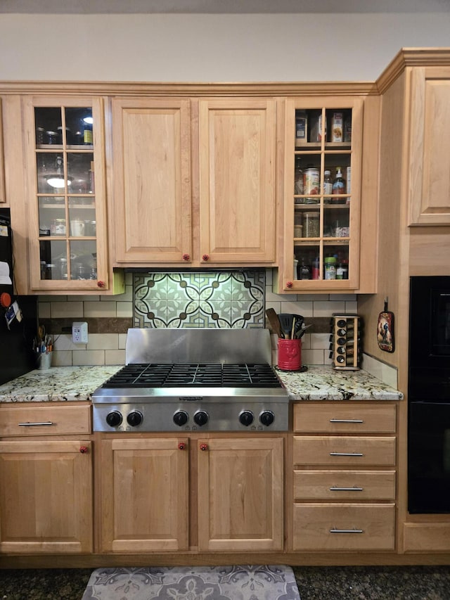 6733 Floyd Hwy S, Willis, VA 24380 - kitchen featuring light brown cabinetry, decorative backsplash, black oven, and stainless steel gas cooktop
