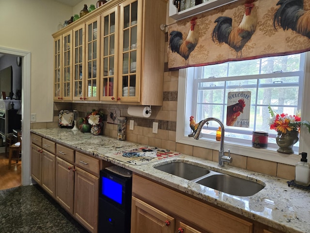 6733 Floyd Hwy S, Willis, VA 24380 - kitchen with a sink, decorative backsplash, glass insert cabinets, and light stone counters
